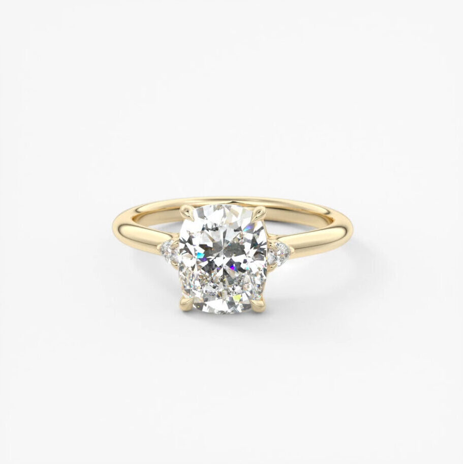 An elongated cushion, lab grown, three stone diamond ring 