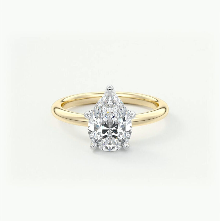 A two tone pear cut diamond engagement ring in 14k yellow gold 