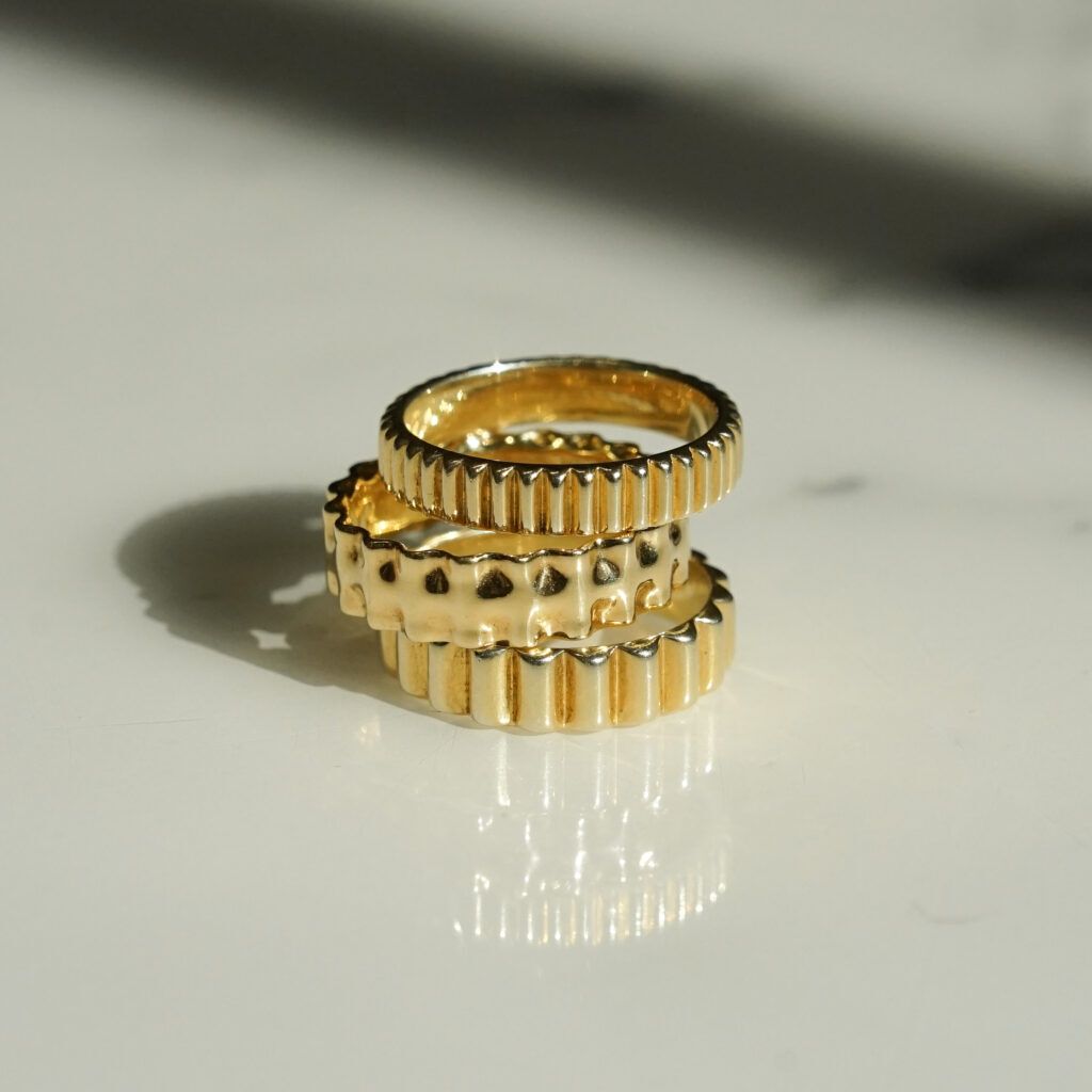 The Rigatoni, Lasagna, and Rigatini wedding bands are stacked on top of each other 
