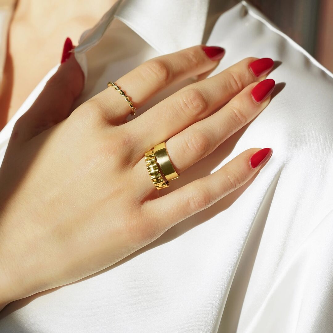 three yellow gold bands are worn 