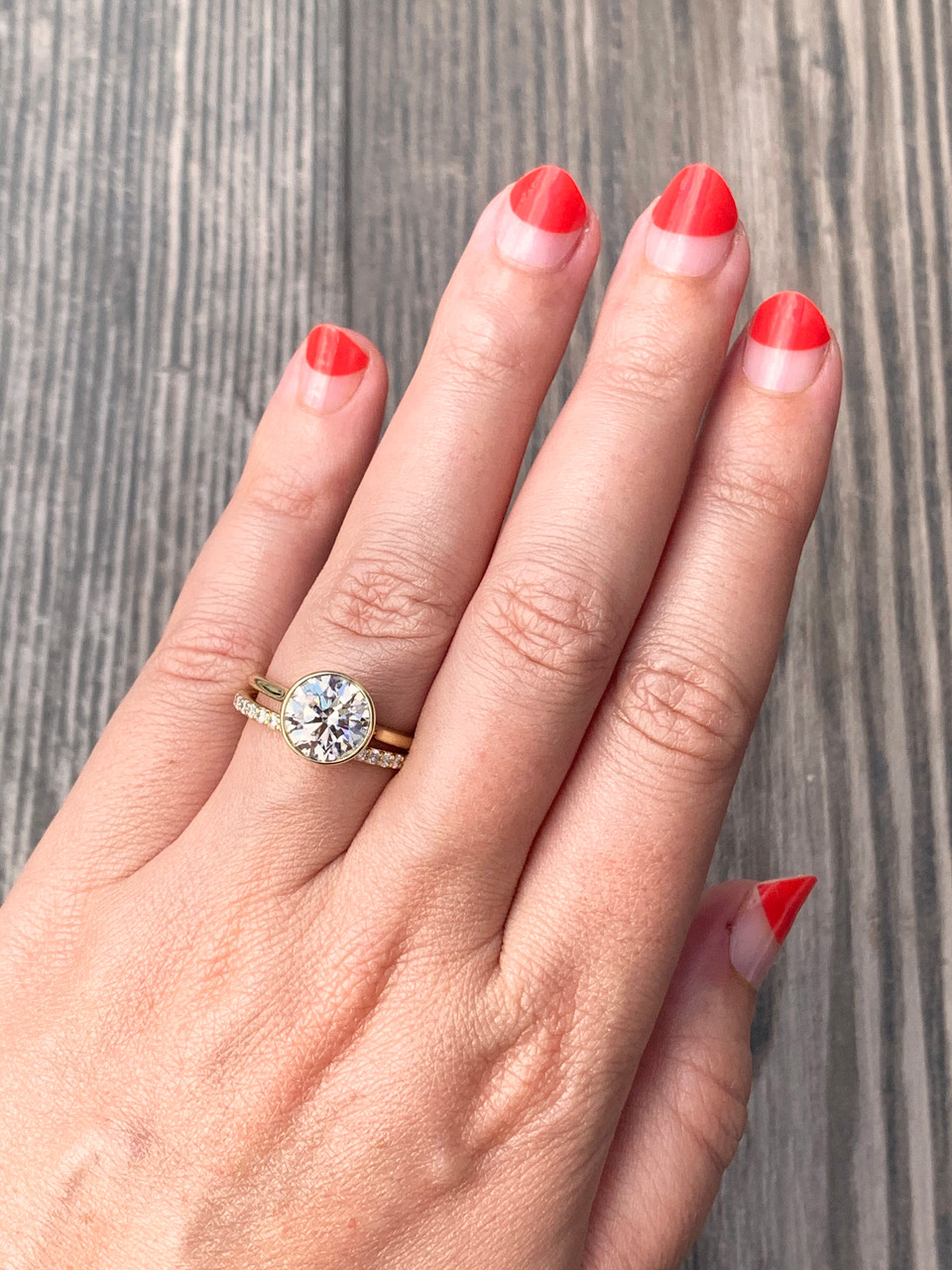Hand wearing a 2.5 carat round diamond bezel set in parker No. 7