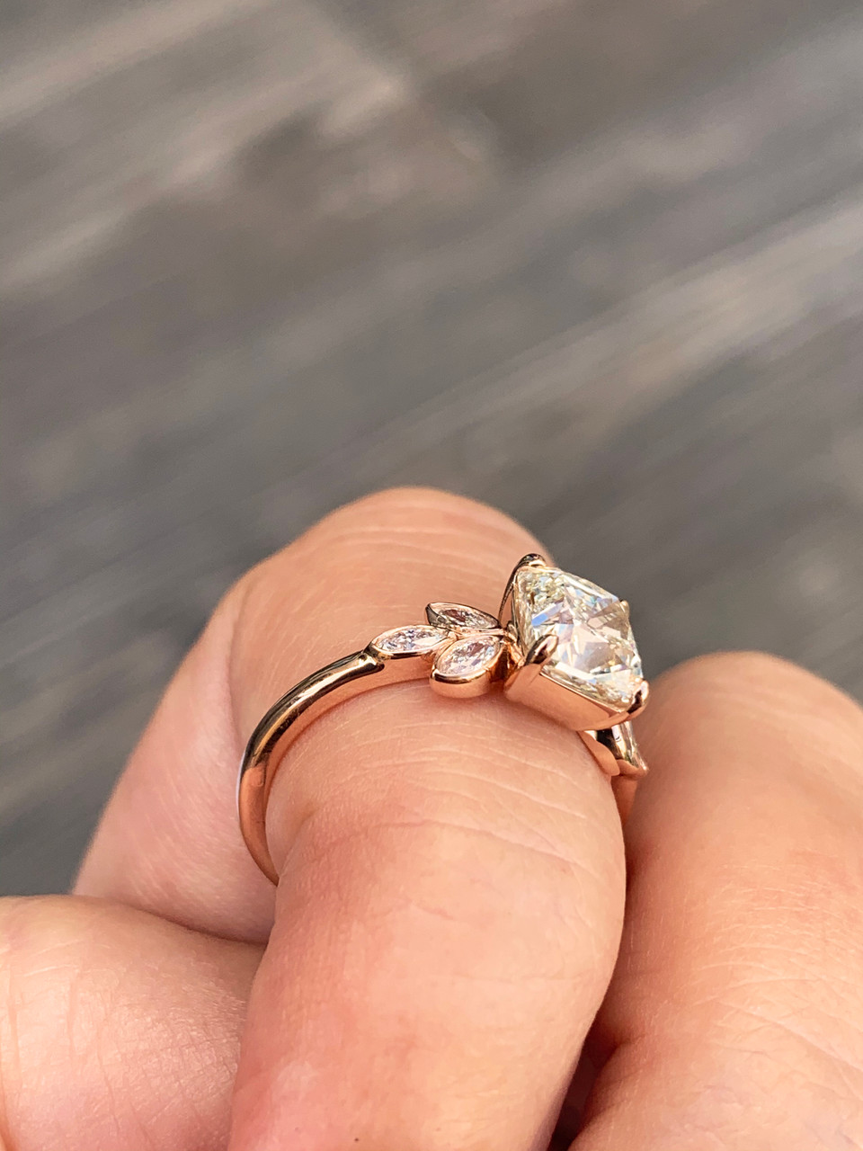 Custom cushion cluster engagement ring with clustered marquise side stones in yellow gold