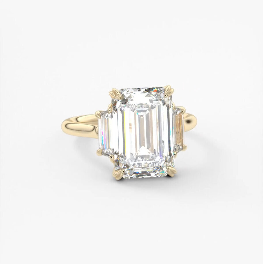 A three stone Emerald and baguette engagement ring in 14k yellow gold 