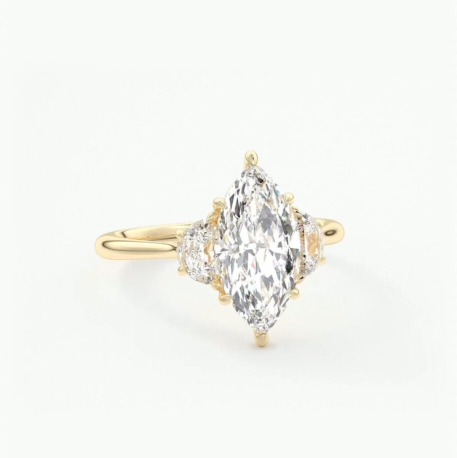 A three stone Marquise and trapezoid engagement ring in 14k yellow gold 
