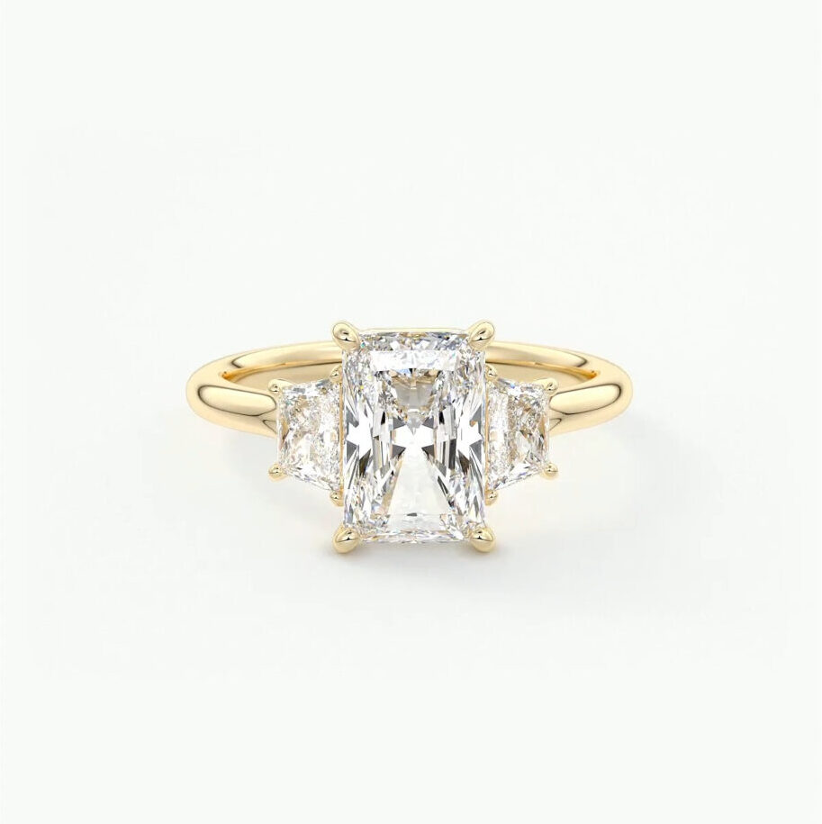 A radiant cut three stone engagement ring with trapezoid side stones in 18k gold 