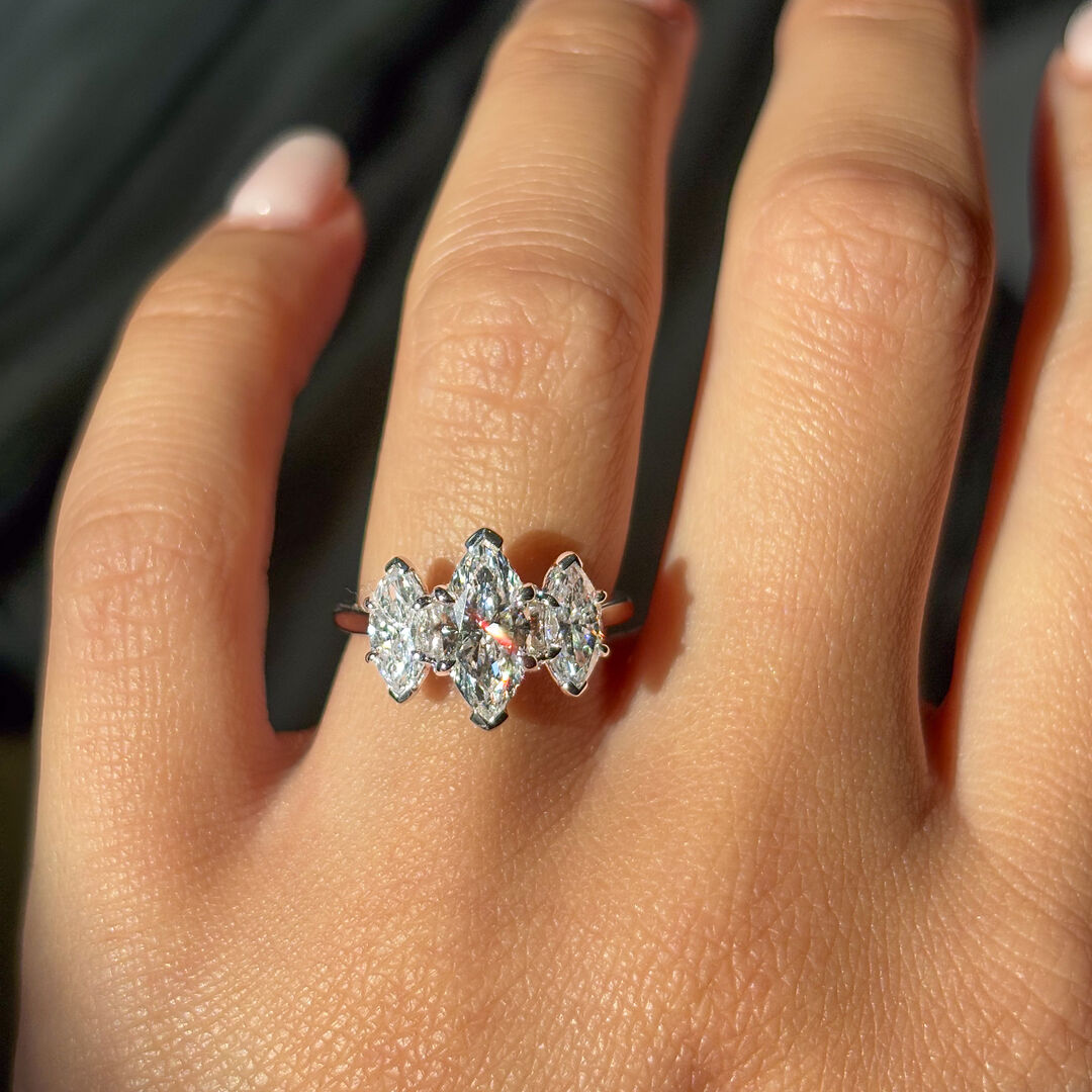 Prong set three stone marquise diamond engagement ring in platinum 