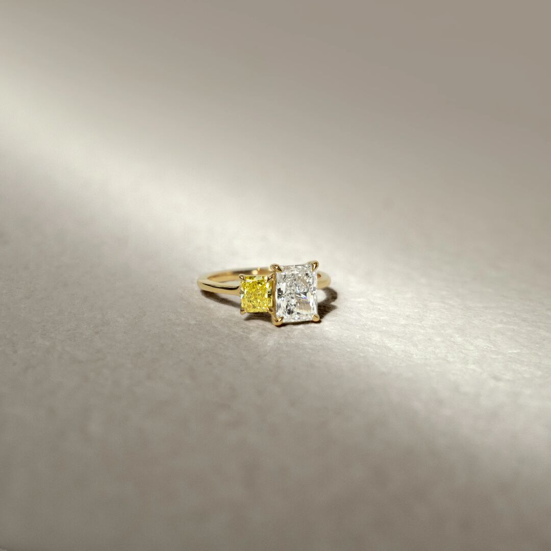 A toi et moi engagement ring with lab grown yellow radiant daimond and colorless radiant cut diamond 
